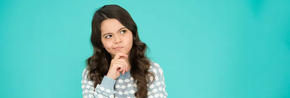 Niña pensando mientras aprende inglés