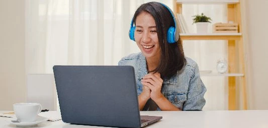 freelance business women casual wear using laptop working call video conference with customer workplace living room home happy young asian girl relax sitting desk job internet 02 - English4Kids