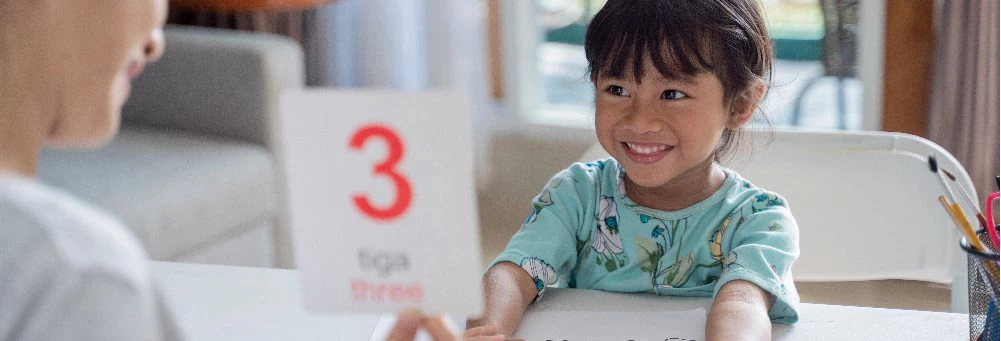 happy kid learning studying together with parent home 02 - English4Kids